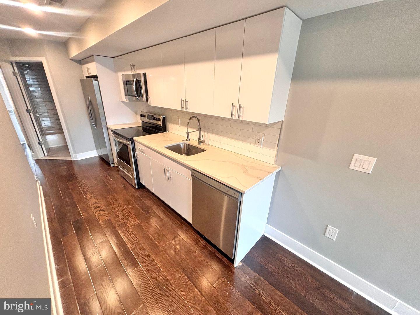 3255 Ridge Avenue Philadelphia, PA 19132 - Photo 2 of 28 a kitchen with a sink stove and cabinets