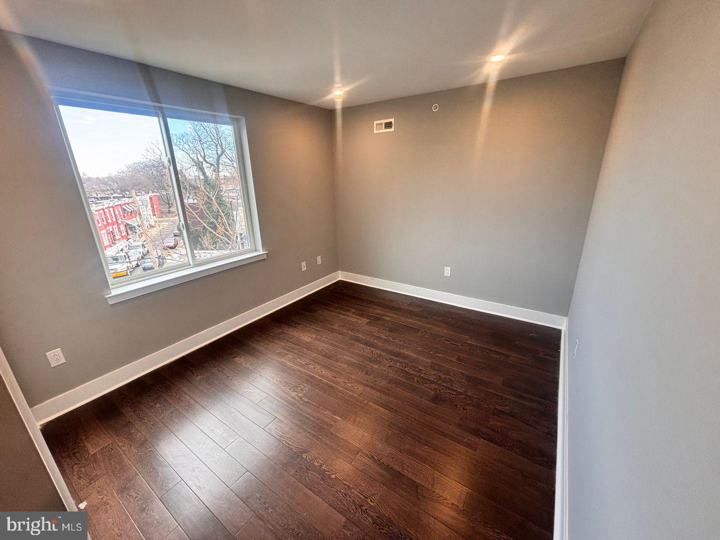 3255 Ridge Avenue Philadelphia, PA 19132 - Photo 21 of 28 a view of an empty room with wooden floor and a window