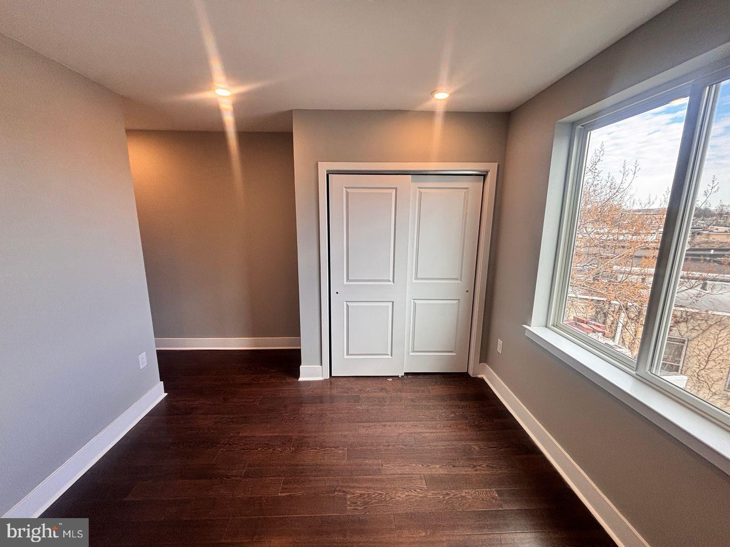 3255 Ridge Avenue Philadelphia, PA 19132 - Photo 23 of 28 an empty room with wooden floor and windows