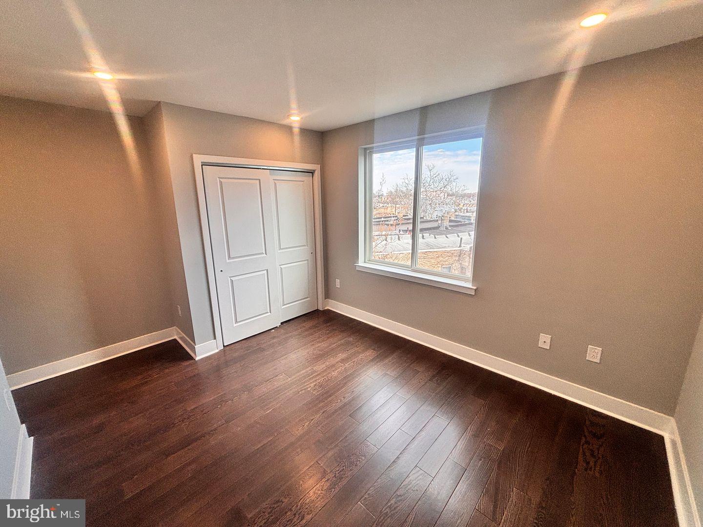 3255 Ridge Avenue Philadelphia, PA 19132 - Photo 24 of 28 an empty room with wooden floor and windows