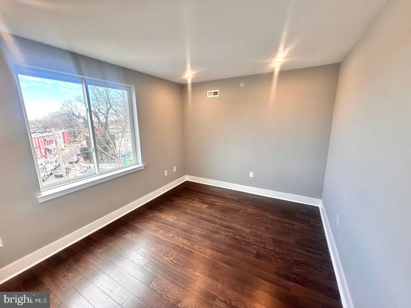 3255 Ridge Avenue Philadelphia, PA 19132 - Photo 25 of 28 a view of an empty room with wooden floor and a window