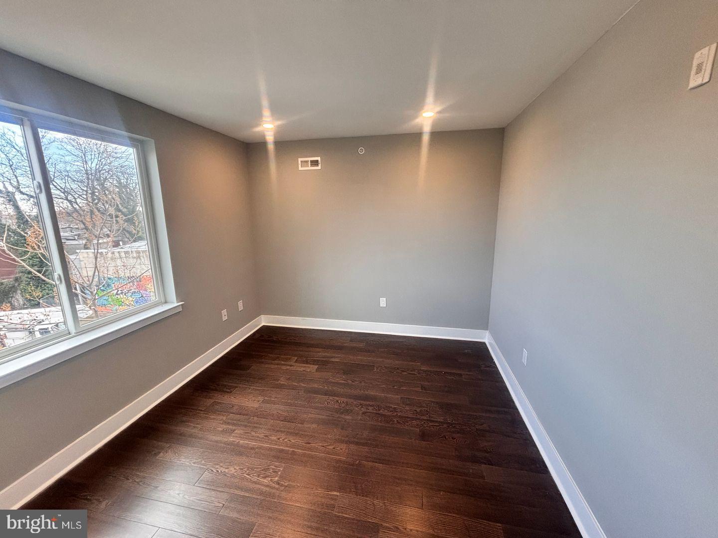 3255 Ridge Avenue Philadelphia, PA 19132 - Photo 26 of 28 a view of an empty room with wooden floor and a window