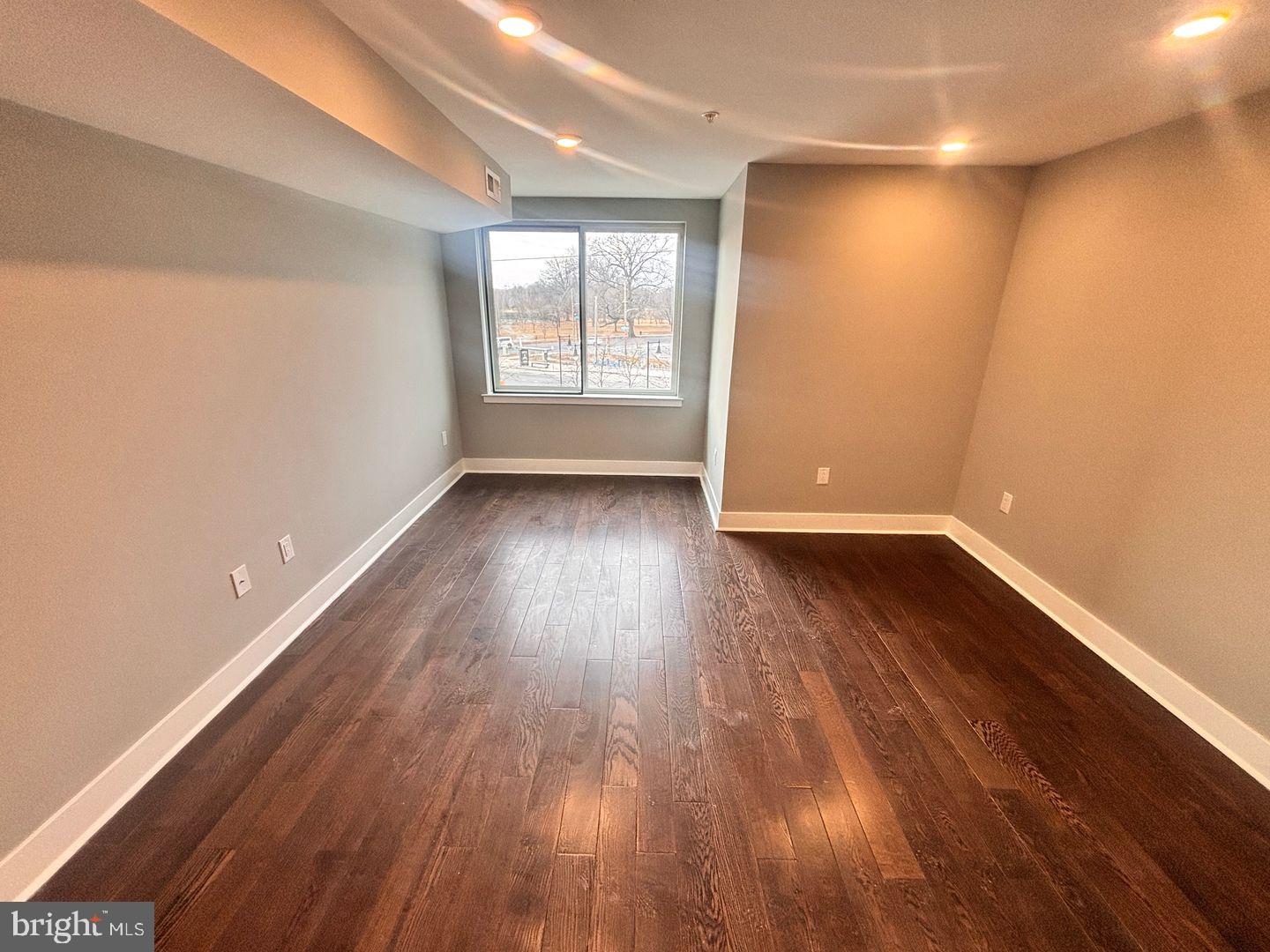 3255 Ridge Avenue Philadelphia, PA 19132 - Photo 6 of 28 an empty room with wooden floor and windows