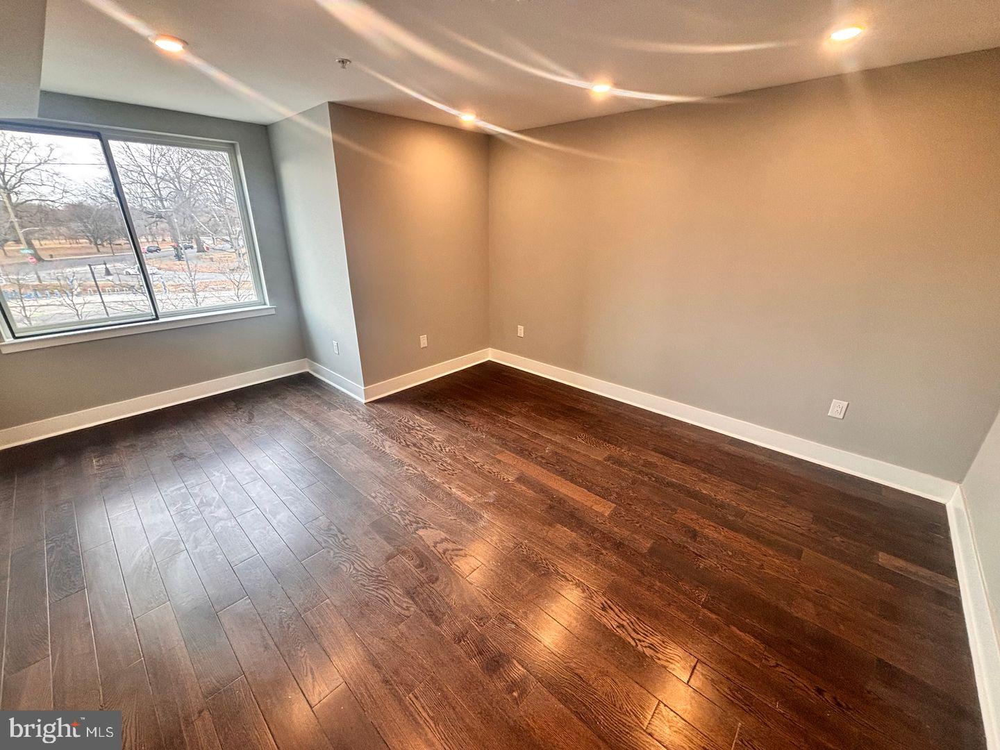 3255 Ridge Avenue Philadelphia, PA 19132 - Photo 7 of 28 an empty room with wooden floor and windows