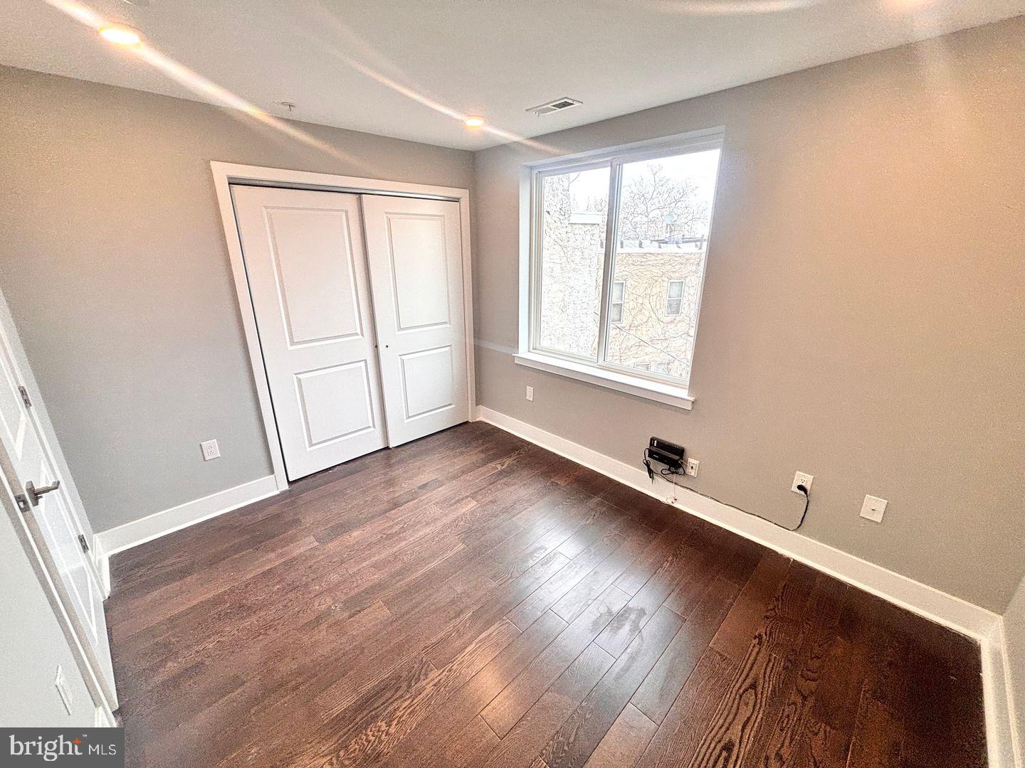 3255 Ridge Avenue Philadelphia, PA 19132 - Photo 9 of 28 an empty room with wooden floor and windows