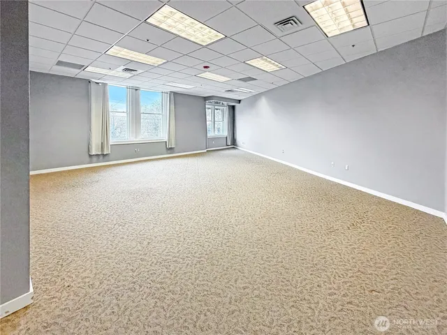 a view of an empty room with windows