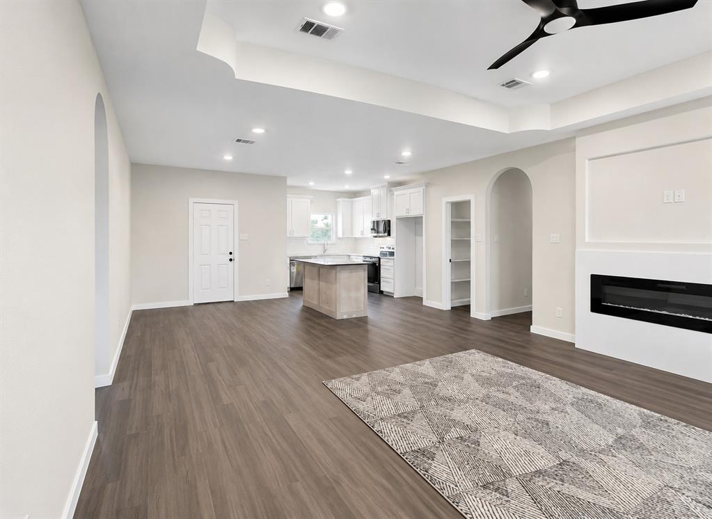 740 Section House Road Ennis, TX 75119 - Photo 8 of 31 a view of kitchen and empty room with wooden floor