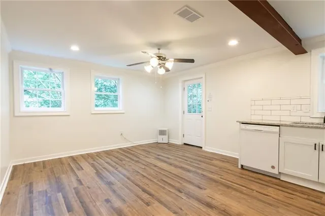 wooden floor in an empty room with a window
