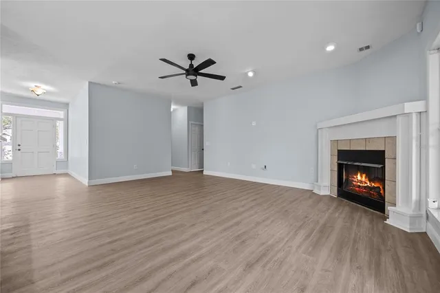 wooden floor in an empty room with a window