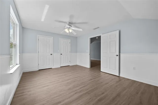 a view of a backyard with wooden fence