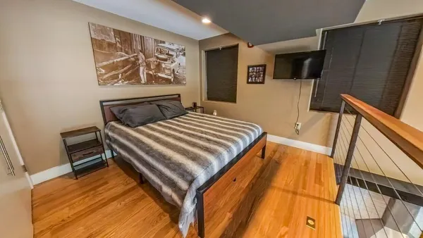 a bedroom with a bed and a flat screen tv