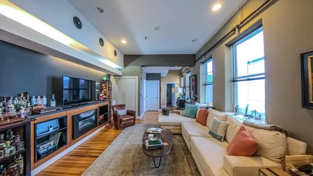 a living room with furniture and a book shelf