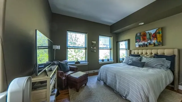 a bedroom with a bed and a large window