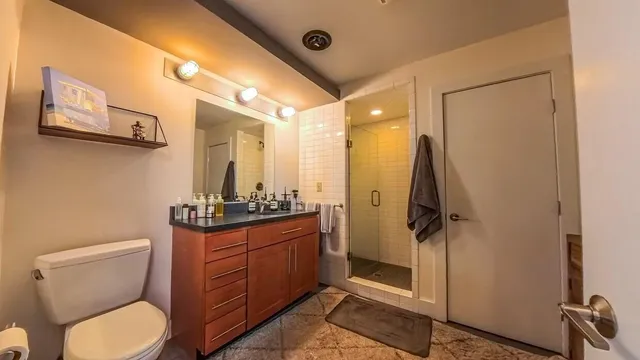 a bathroom with a toilet a sink and mirror