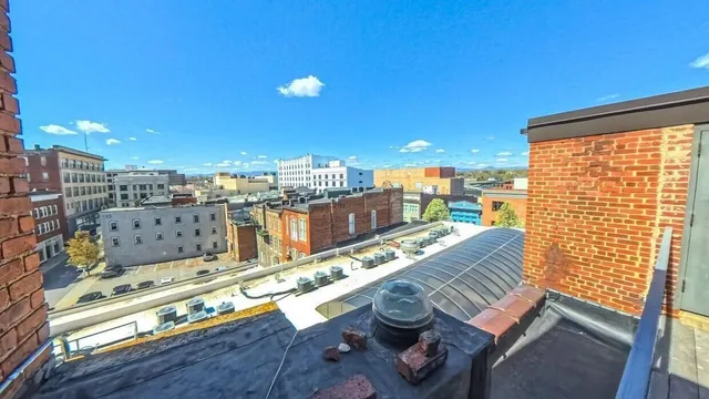 a view of a balcony with an outdoor seating