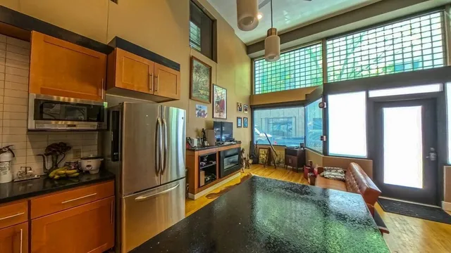 a kitchen with a refrigerator and a sink