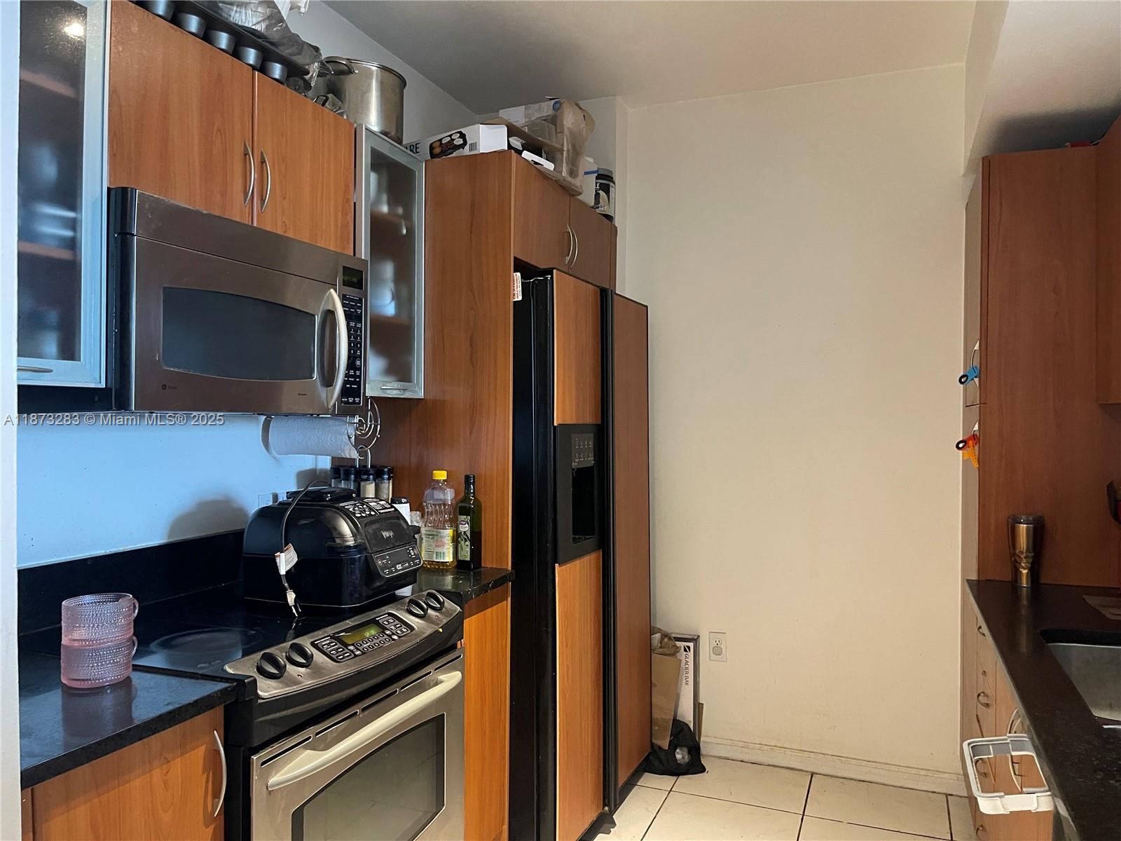 a kitchen with stainless steel appliances a stove and a microwave