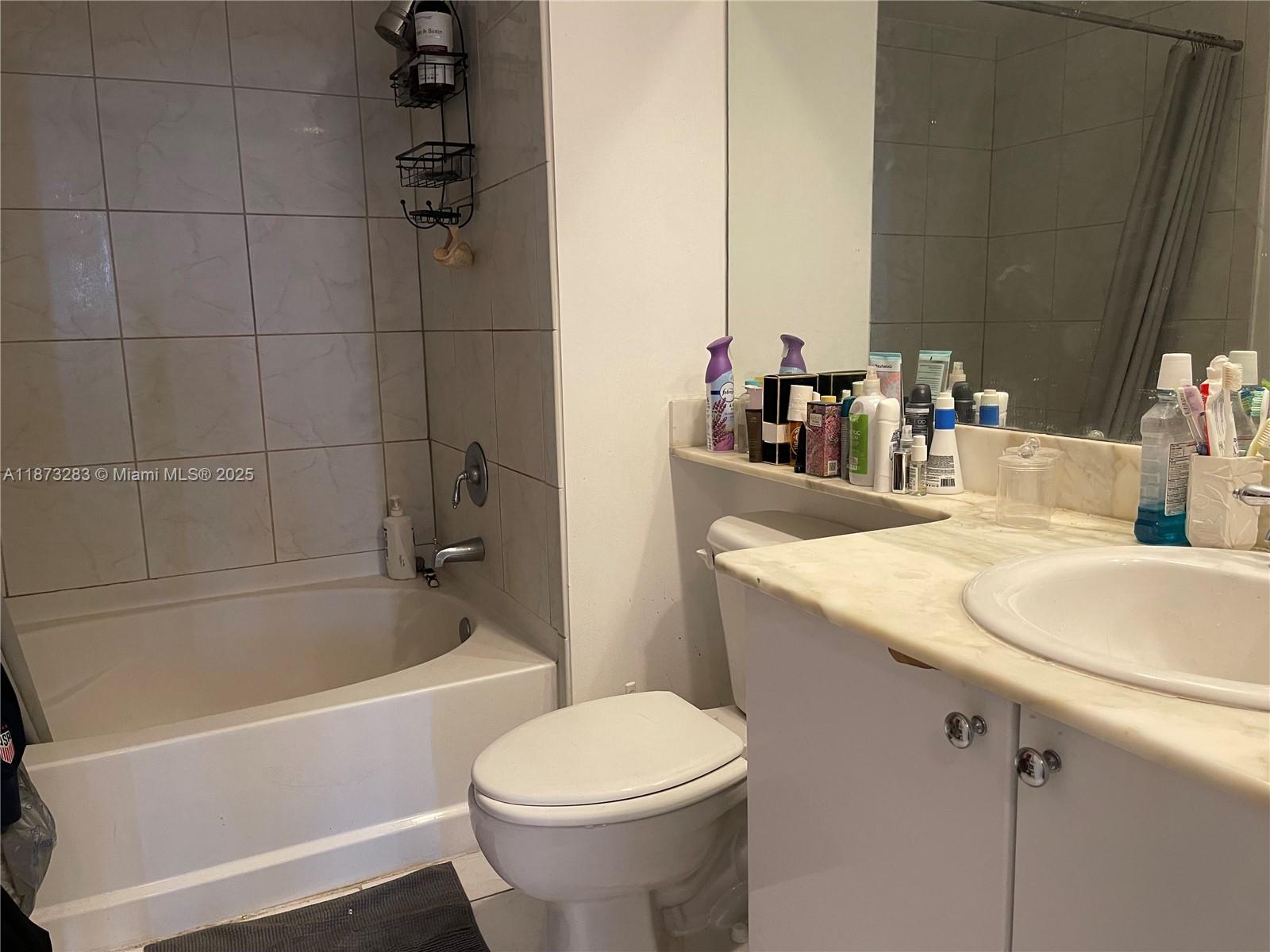 2775 Northeast 187th Street, Unit 205 Aventura, FL 33180 - Photo 11 of 53 a bathroom with a granite countertop sink toilet and shower