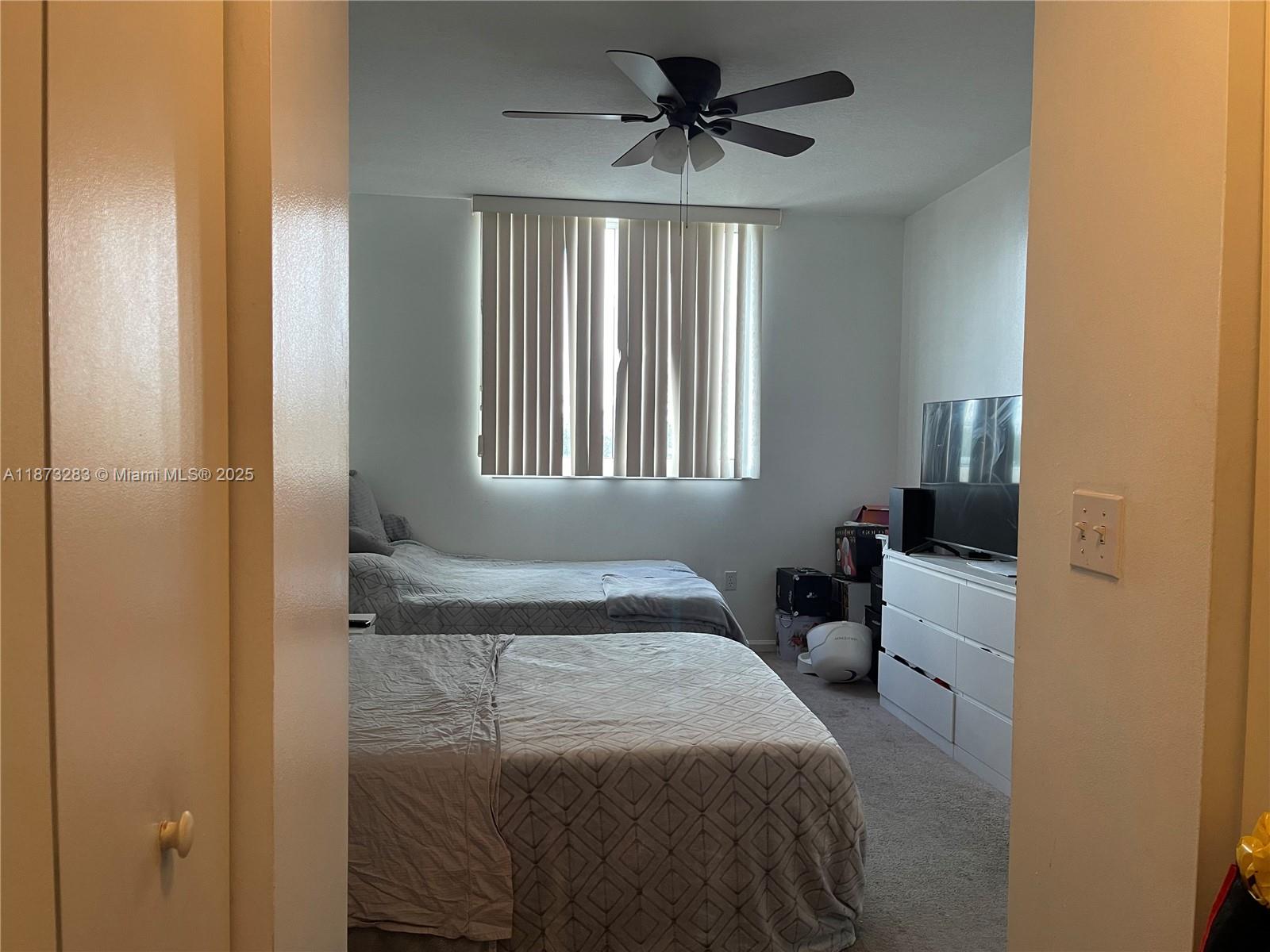 2775 Northeast 187th Street, Unit 205 Aventura, FL 33180 - Photo 12 of 53 a bedroom with a bed and a window
