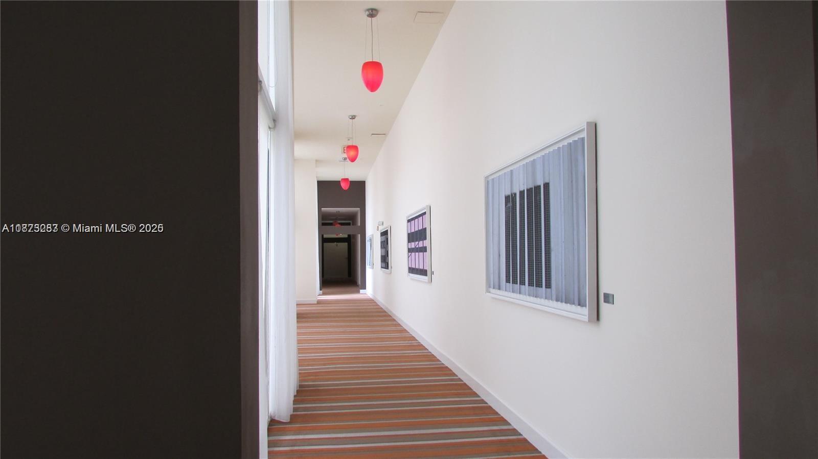 2775 Northeast 187th Street, Unit 205 Aventura, FL 33180 - Photo 27 of 53 a hallway with stairs and a refrigerator