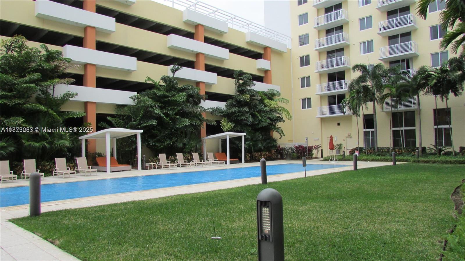 2775 Northeast 187th Street, Unit 205 Aventura, FL 33180 - Photo 32 of 53 a house with palm trees in front of it
