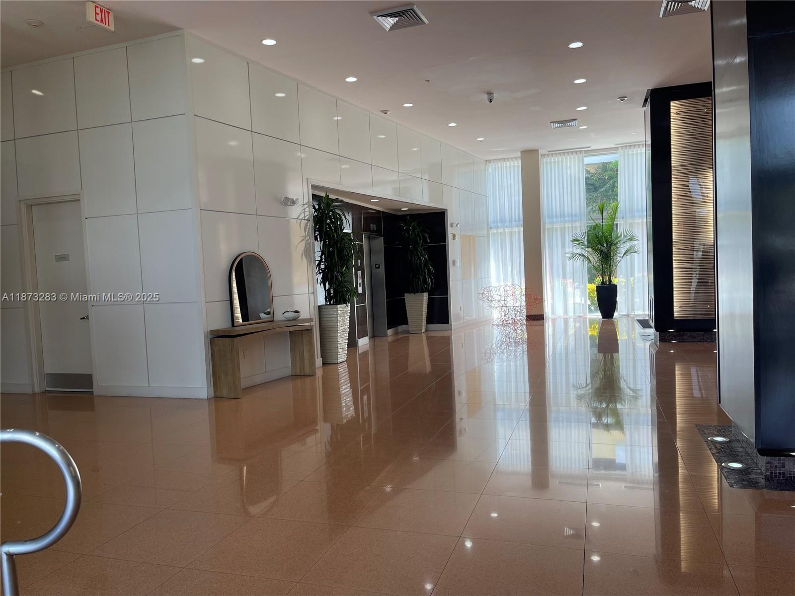 2775 Northeast 187th Street, Unit 205 Aventura, FL 33180 - Photo 36 of 53 a kitchen with stainless steel appliances a refrigerator and a sink