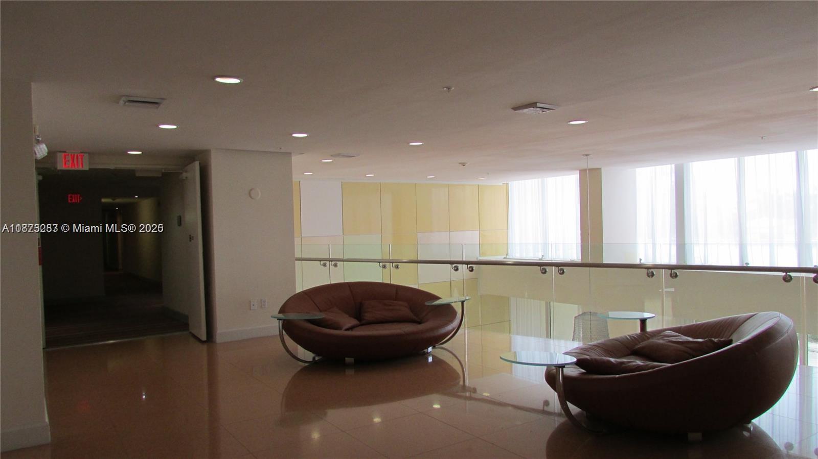 2775 Northeast 187th Street, Unit 205 Aventura, FL 33180 - Photo 42 of 53 a view of a lobby with a couch and a potted plant