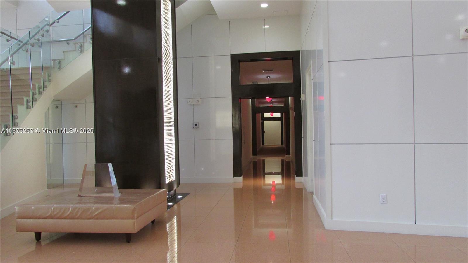 2775 Northeast 187th Street, Unit 205 Aventura, FL 33180 - Photo 50 of 53 a living room with furniture and a gate