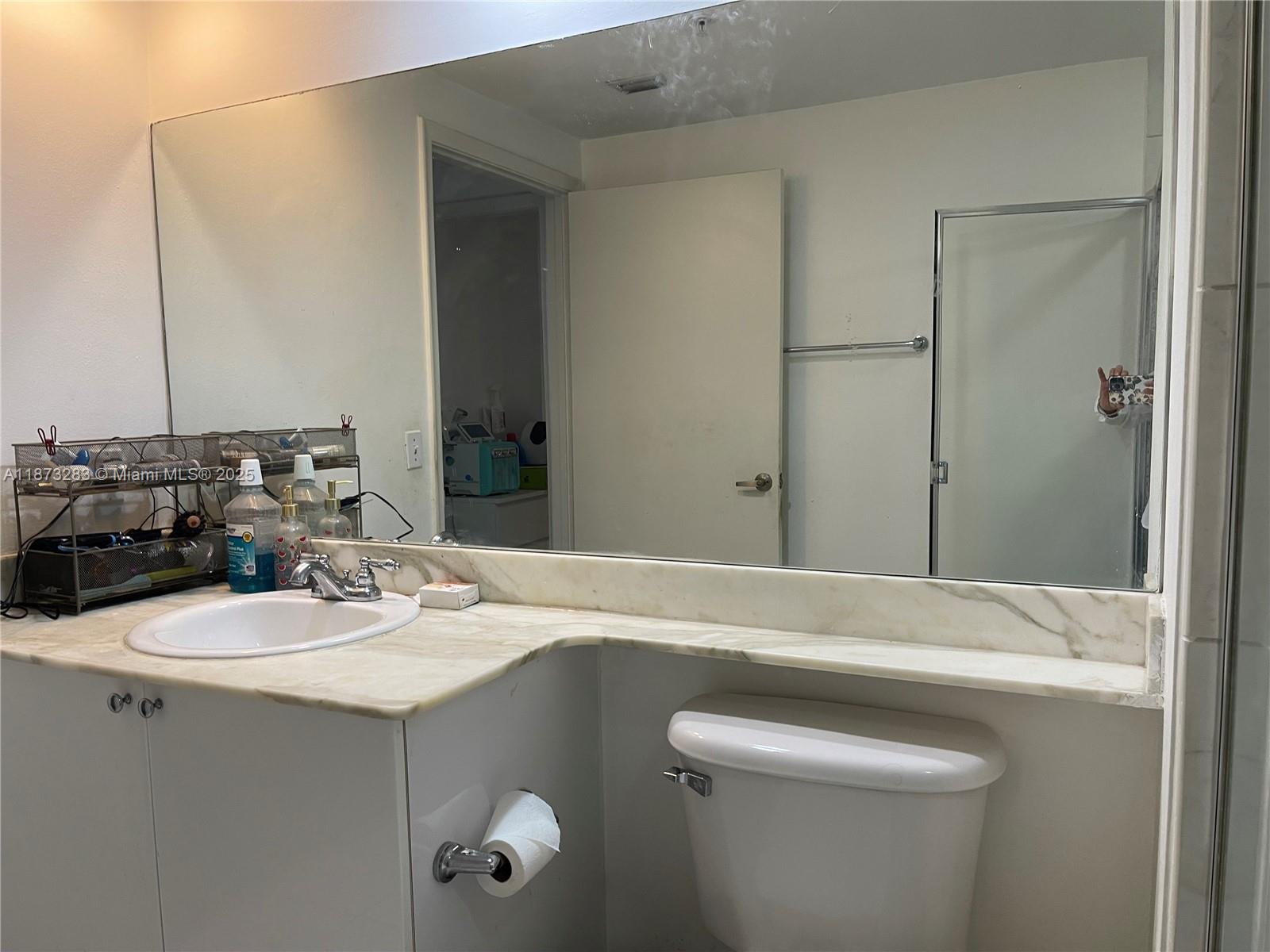 2775 Northeast 187th Street, Unit 205 Aventura, FL 33180 - Photo 5 of 53 a bathroom with a sink and mirror
