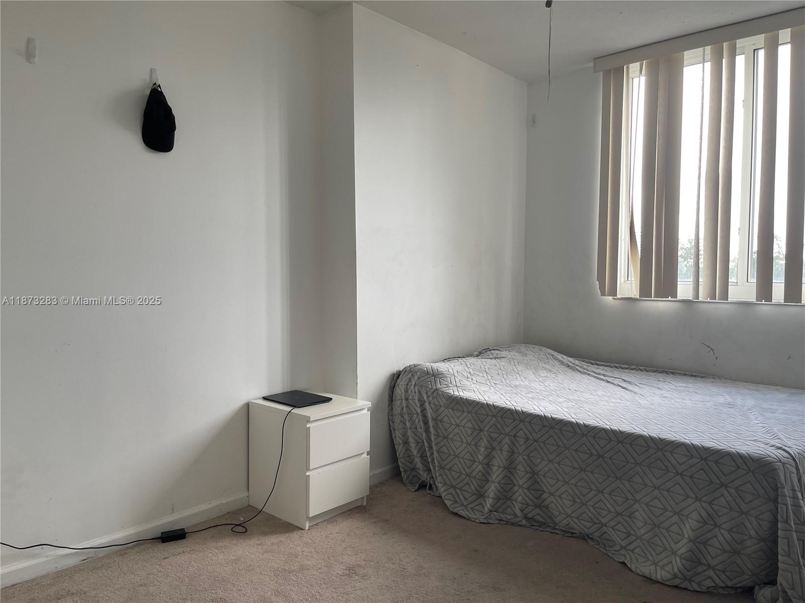 2775 Northeast 187th Street, Unit 205 Aventura, FL 33180 - Photo 6 of 53 a bedroom with a bed and a window