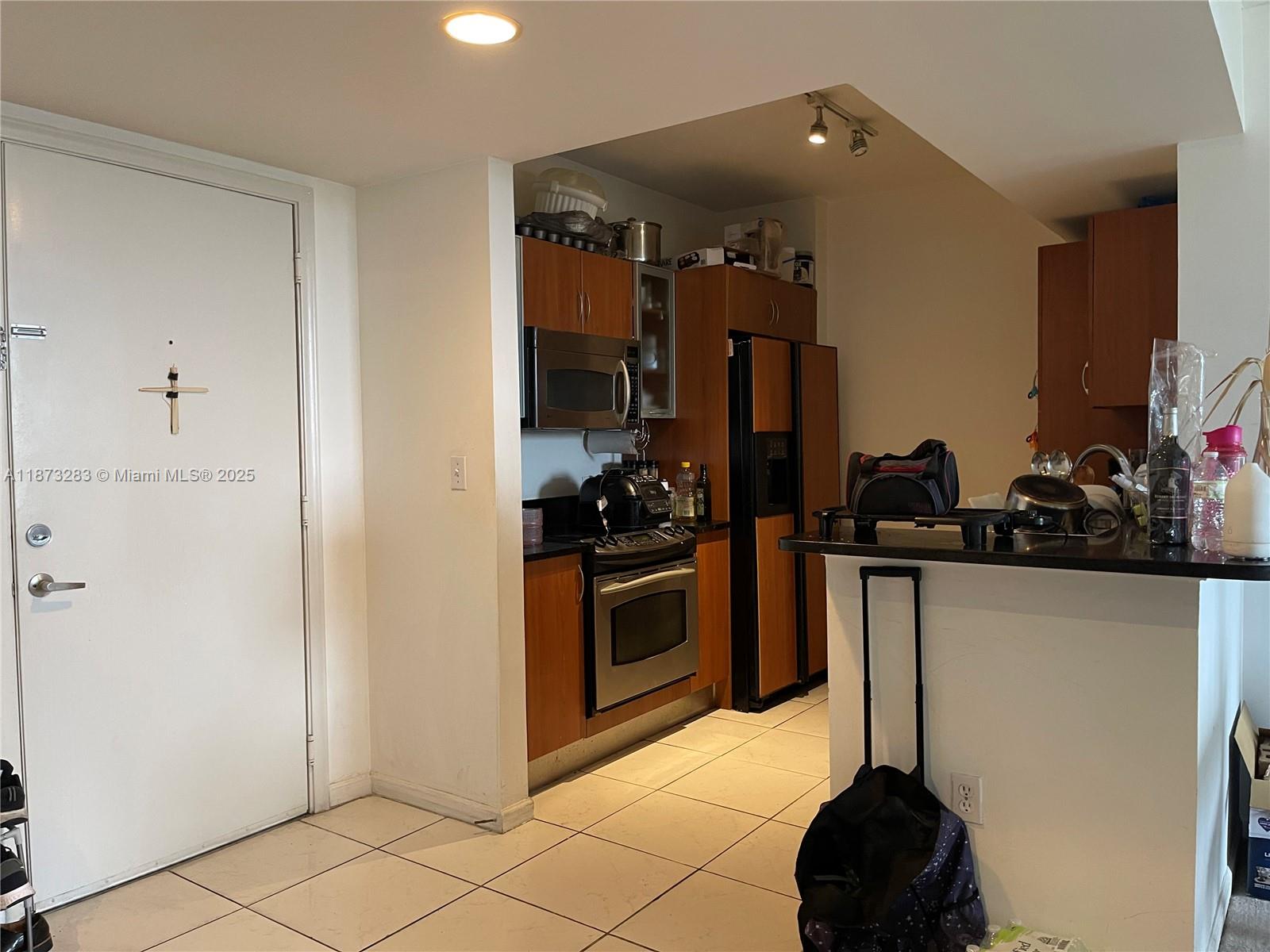 2775 Northeast 187th Street, Unit 205 Aventura, FL 33180 - Photo 10 of 53 a kitchen with a sink and cabinets