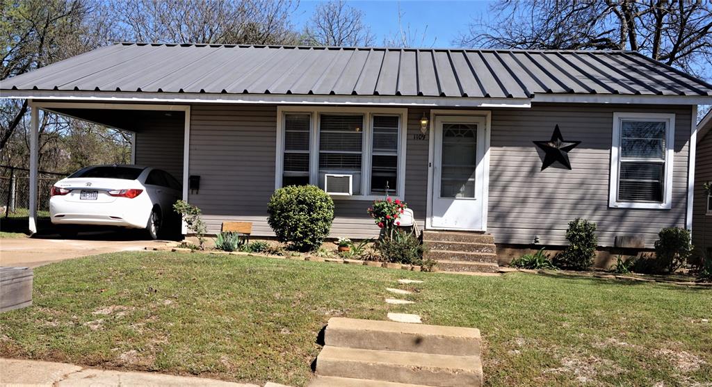 1109 West Morgan Street Denison, TX 75020 - Photo 1 of 1 a front view of a house with garden