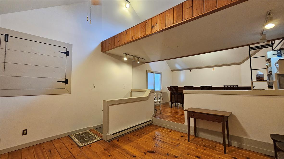 585 Buttermilk Road Hellertown, PA 18055 - Photo 76 of 82 Natural wood flooring complements this generously sized room, offering a welcoming atmosphere.