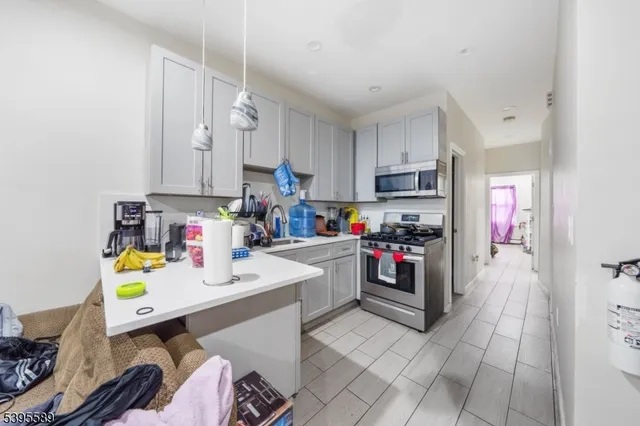 a kitchen with a sink appliances and cabinets