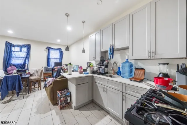 a kitchen with a sink stove and cabinets