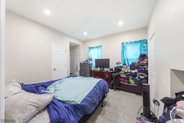 a bedroom with furniture and a flat screen tv