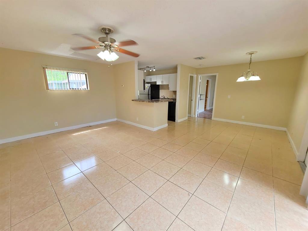 a view of a kitchen with furniture and a chandelier fan