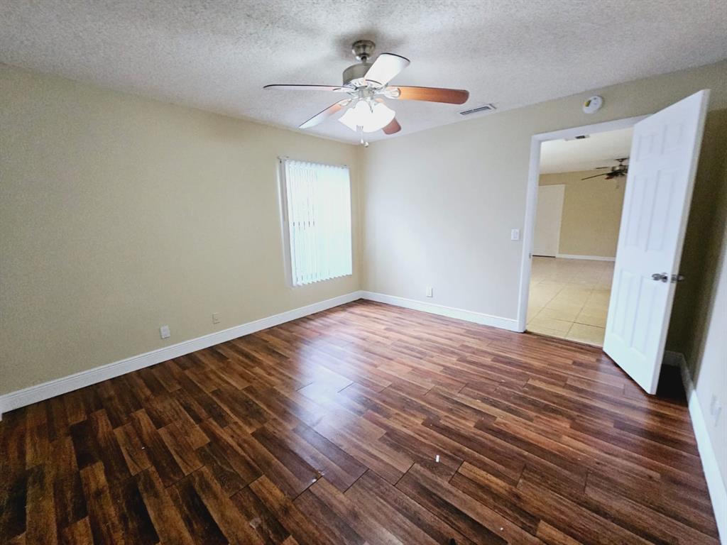 2 Crossings Circle, Unit G Boynton Beach, FL 33435 - Photo 12 of 22 a view of an empty room with wooden floor and a window