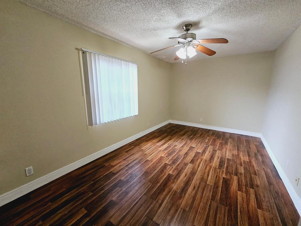 2 Crossings Circle, Unit G Boynton Beach, FL 33435 - Photo 7 of 22 wooden floor in an empty room with a window