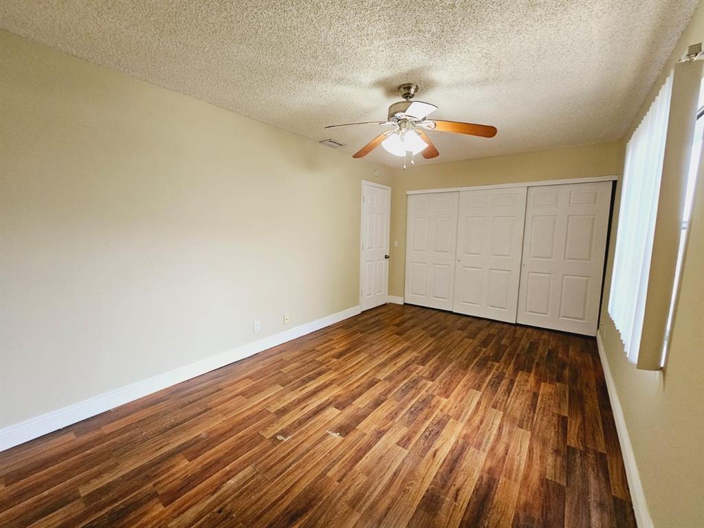2 Crossings Circle, Unit G Boynton Beach, FL 33435 - Photo 8 of 22 wooden floor in an empty room with a window