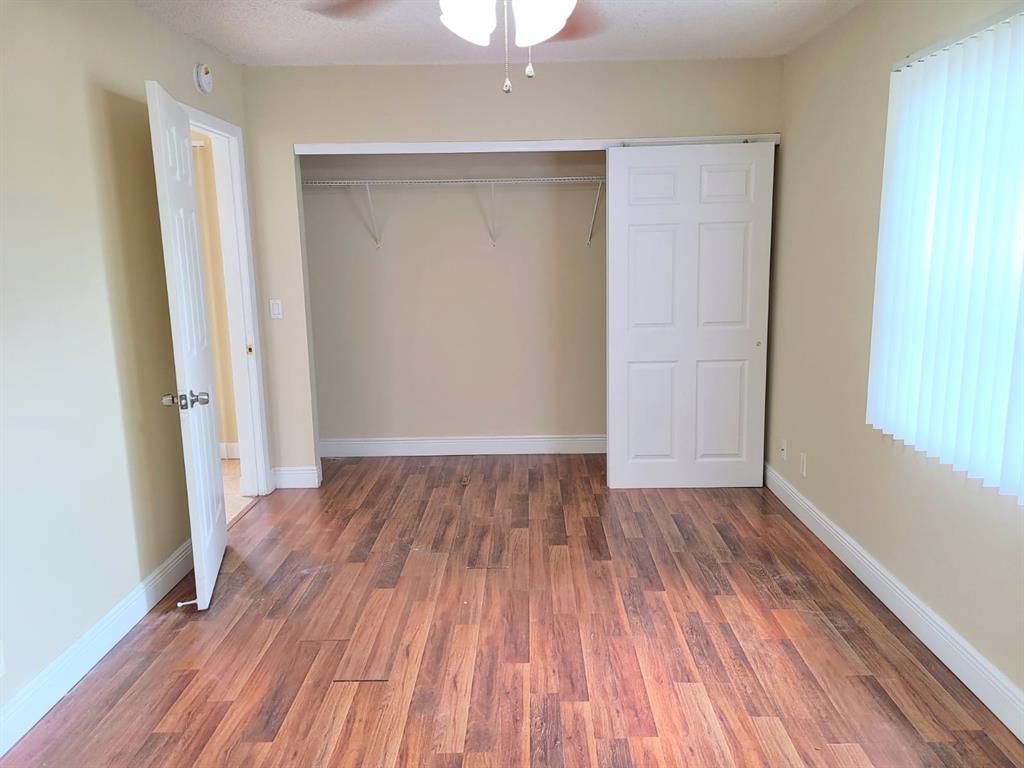 2 Crossings Circle, Unit G Boynton Beach, FL 33435 - Photo 9 of 22 an empty room with wooden floor and a window