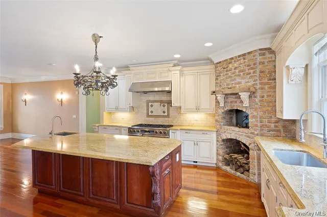 a kitchen with a stove a sink and a cabinets
