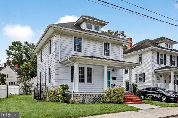 a front view of a house with a garden and plants