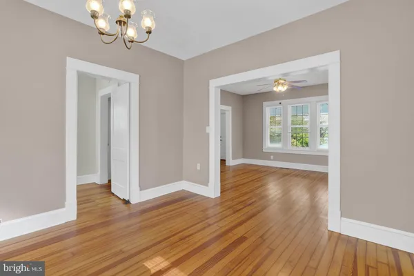 a view of a room with wooden floor and window