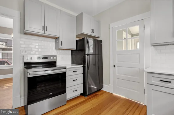 a kitchen with a stove and a refrigerator