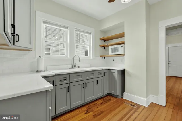 a spacious bathroom with a double vanity sink a mirror and a bathtub