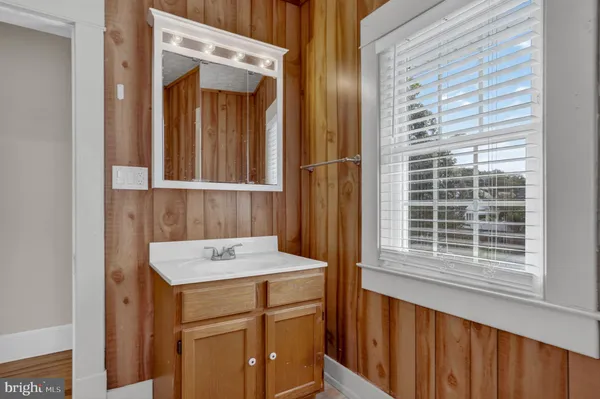 a bathroom with a sink a vanity and a window