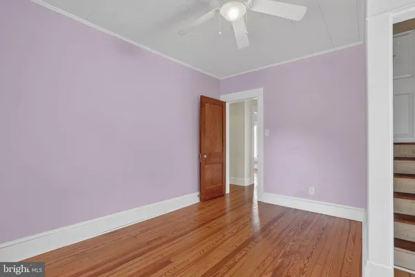 a view of an empty room with wooden floor