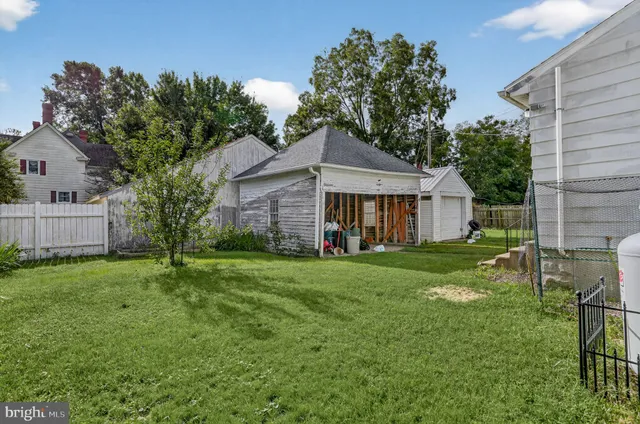 a view of a backyard with a garden and entertaining space