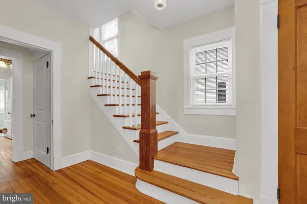 a view of entryway with wooden floor and stairs